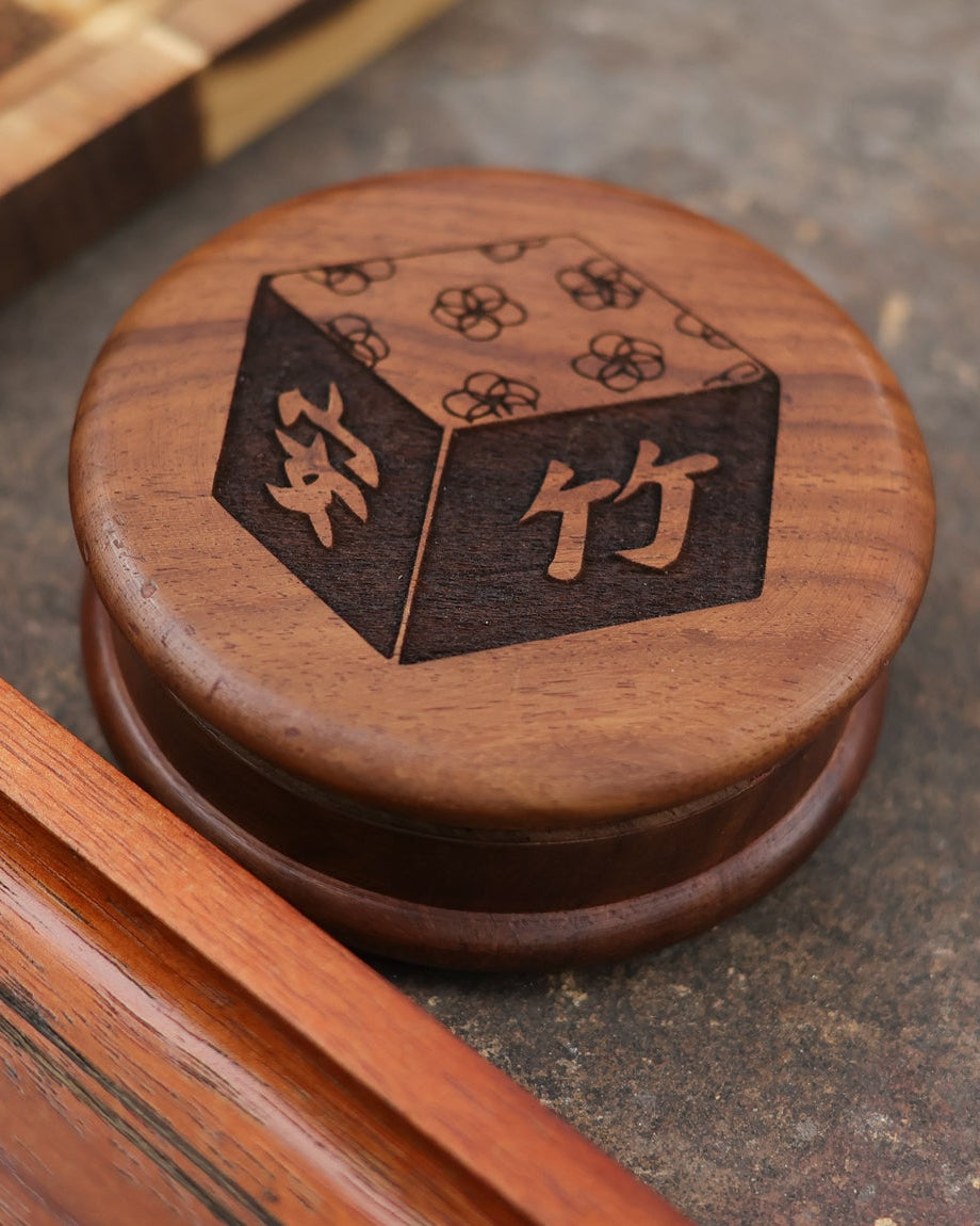 Wooden object with engraved design on a textured surface